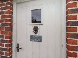 A door with a lion knocker and a name plate at Bubbs Cottage