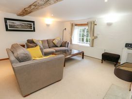 A living room with a sofa and coffee table at Bubbs Cottage 