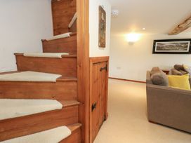 Stairs leading to the upper level in a living room at Bubbs Cottage