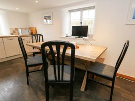 A kitchen with a dining table and chairs at Bubbs Cottage