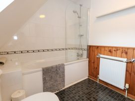 A bathroom with a bathtub and shower at Bubbs Cottage