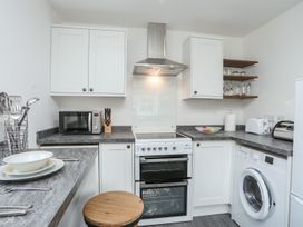 A kitchen with appliances and utensils at Bryn Bach in Pentraeth