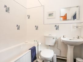 A bathroom with a bathtub, toilet, and sink at Bryn Bach in Pentraeth
