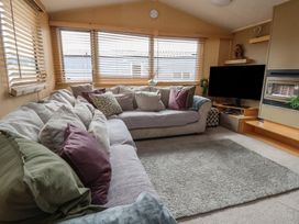 A living room with a sofa and television at Caravan 596 Prestatyn
