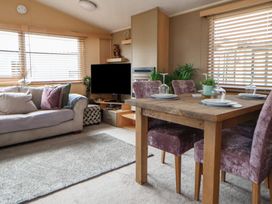 A living room with a sofa and dining table at Caravan 596 in Prestatyn