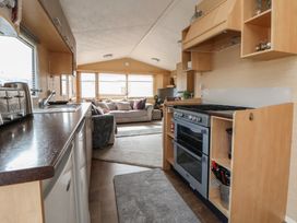 A kitchen with an oven and sink at Caravan 596 in Prestatyn