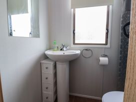 A bathroom with a sink and mirror at Caravan 596 Prestatyn