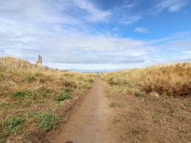 A path surrounded by grass and a fence at Caravan 596 in Prestatyn