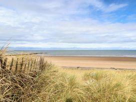 A beach with sand and water at Caravan 596 Prestatyn