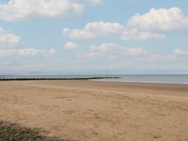 A beach with sand and water at Caravan 596 in Prestatyn