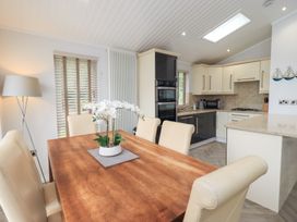 A dining room with a table and chairs at Laughing Duck in Troutbeck Bridge