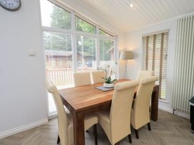 A dining room with a wooden table and chairs at Laughing Duck in Troutbeck Bridge