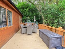 A deck area with a table and chairs at Laughing Duck in Troutbeck Bridge