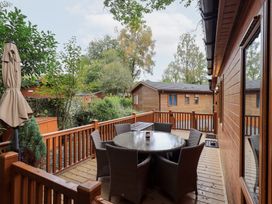 An outdoor patio with a table and chairs at Laughing Duck in Troutbeck Bridge