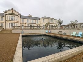 An outdoor area with a fountain and seating at Costal Lodge at Seaham Hall, Seaham