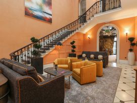 A lobby with a staircase and seating area at Costal Lodge at Seaham Hall Seaham