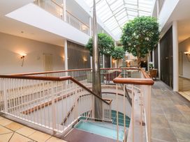 An atrium with a staircase and indoor plants at Costal Lodge at Seaham Hall Seaham