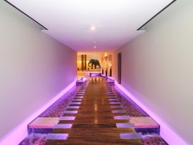 A hallway with a wooden walkway and a sculpture at Costal Lodge at Seaham Hall, Seaham