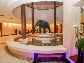 A lobby with an elephant statue and a fountain at Costal Lodge at Seaham Hall Seaham