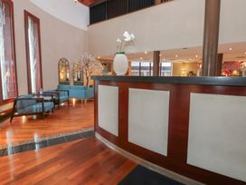 A lobby with a reception desk and seating areas at Costal Lodge at Seaham Hall Seaham