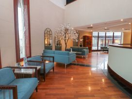 A lobby with seating and decorative elements at Costal Lodge at Seaham Hall Seaham