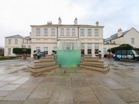 An outdoor area with a fountain and building at Costal Lodge at Seaham Hall Seaham