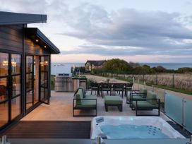 An outdoor patio with seating and a hot tub at Costal Lodge at Seaham Hall, Seaham