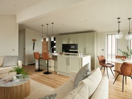 A kitchen with a dining area and seating at Costal Lodge at Seaham Hall Seaham