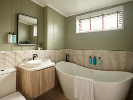 A bathroom with a bathtub, sink, and toilet at Costal Lodge at Seaham Hall Seaham