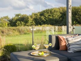 A patio with cocktail glasses and cushions at Costal Lodge at Seaham Hall in Seaham