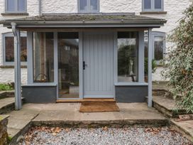 An entryway with a grey door and windows at 3 bed property