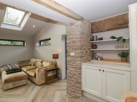 A living room with a sofa and shelving at 3 bed property