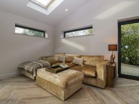 A living room with a sofa and an ottoman at a 3 bed property