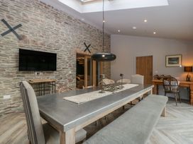 A dining area with a large table and chairs at 3 bed property