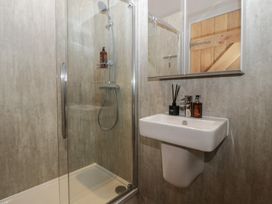 A bathroom with a shower and sink at 3 bed property