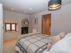 A bedroom with a bed and mirror at 3 bed property 