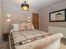 A bedroom with a bed and lamp at 3 bed property