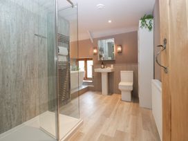 A bathroom with shower, bathtub, toilet, and sink at 3 bed property