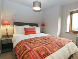 A bedroom with a bed and lamps at 3 bed property