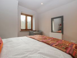A bedroom with a bed and window at 3 bed property 