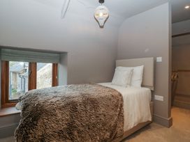 A bedroom with a bed and window at 3 bed property