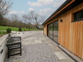 An outdoor area with a bench and gravel at a 3 bed property