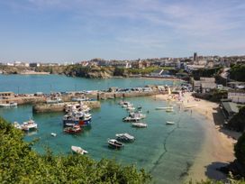 A view of the harbor with boats and beach at Higher Tower Road