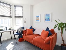 A living room with a sofa and a dining table at Higher Tower Road 