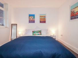 A bedroom with a bed and wall art at Higher Tower Road 