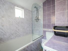 A bathroom with a bathtub, shower, toilet and sink at Higher Tower Road