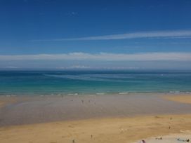 A beach with sand and ocean waves at Higher Tower Road 
