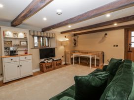 A living room with a television and sofa at 1 bed property Usk