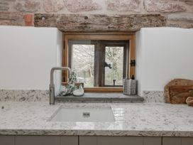 A kitchen with a sink and window at 1 bed property in Usk