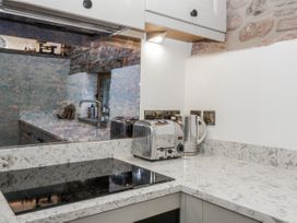 A kitchen with a countertop, toaster, kettle, and stove at 1 bed property Usk